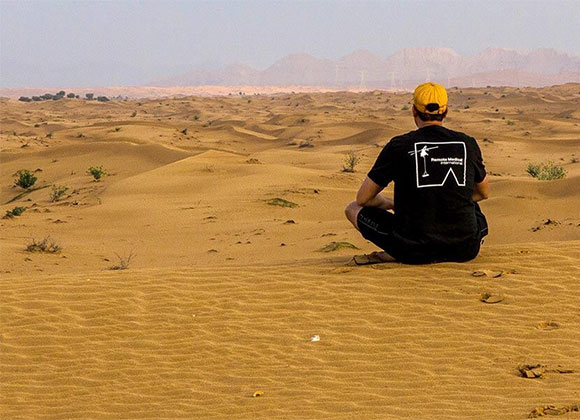 RMI Employee sitting in desert